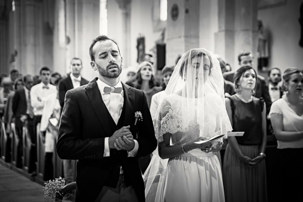 Mariés recueillis pendant la cérémonie religieuse — photographe de mariage à Paray-le-Monial